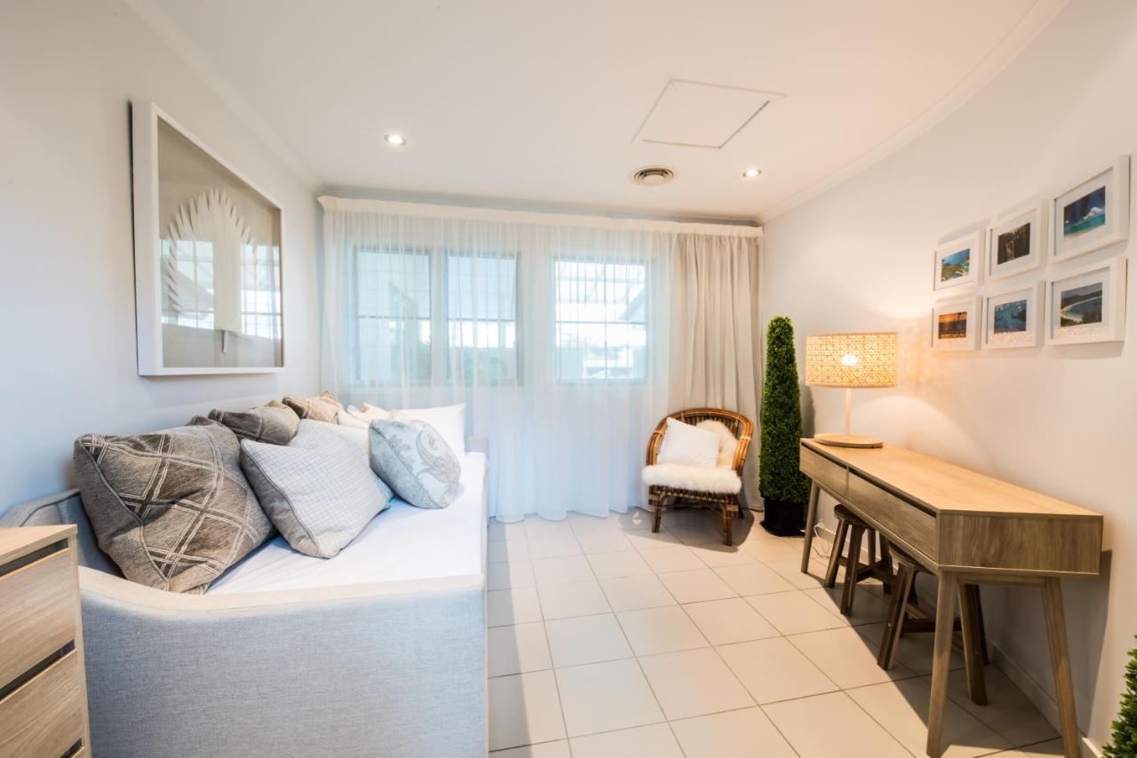 At Marina Shores Airlie Beach Exterior photo A living room in a typical apartment at The Standard East Village